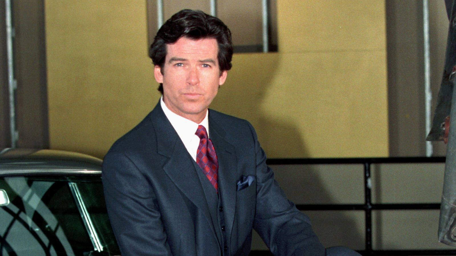 pierce brosnan on a yellow background