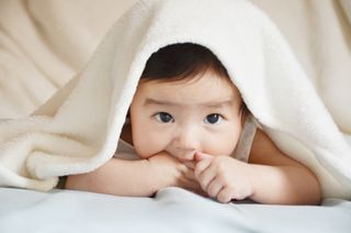 Baby under blanket