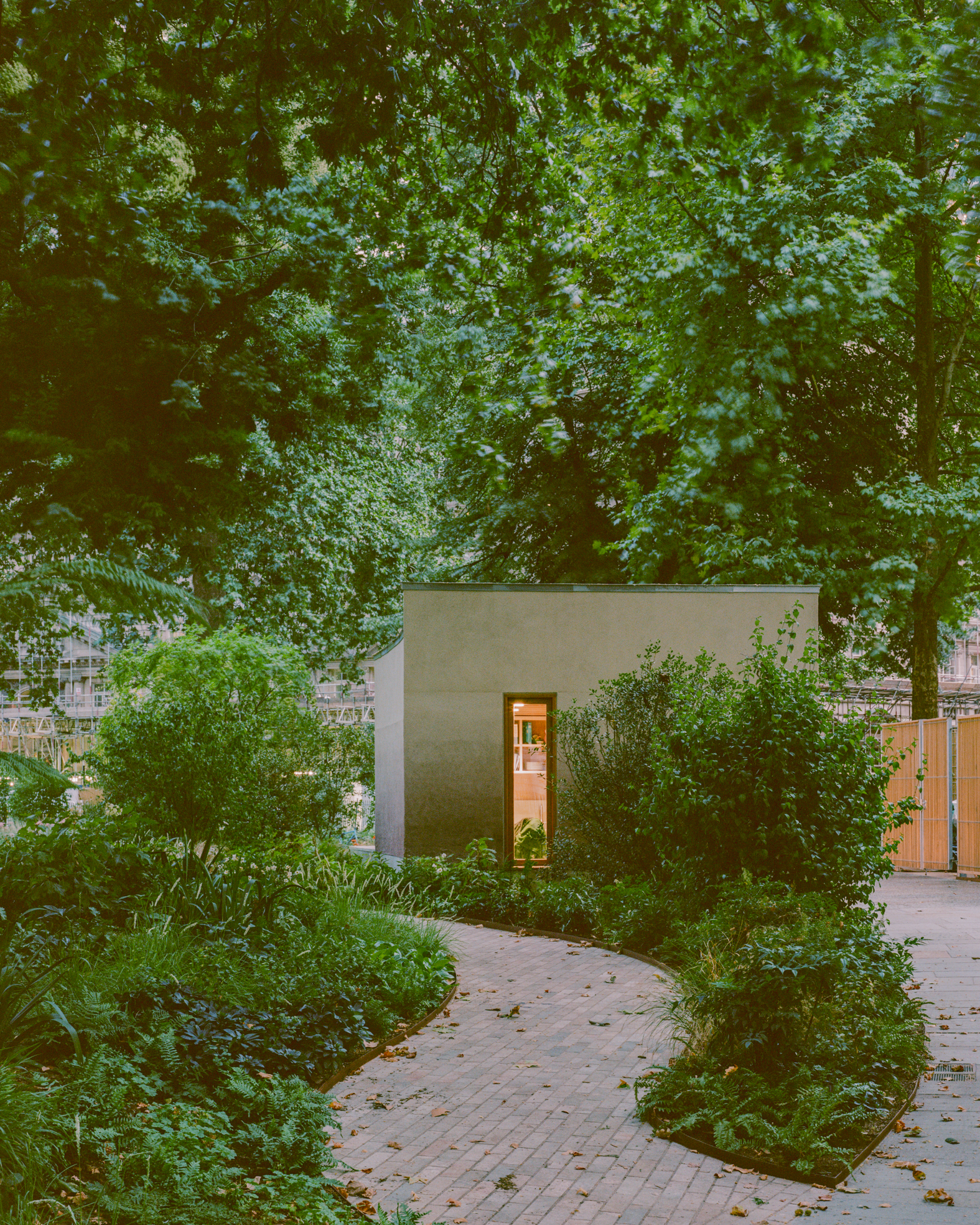 view of Finsbury Circus Parks Office, a minimalist, earthy building set among leafy garden