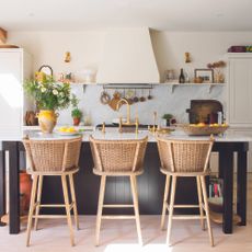 Classic kitchen with island and rattan chairs