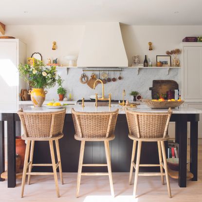 Classic kitchen with island and rattan chairs