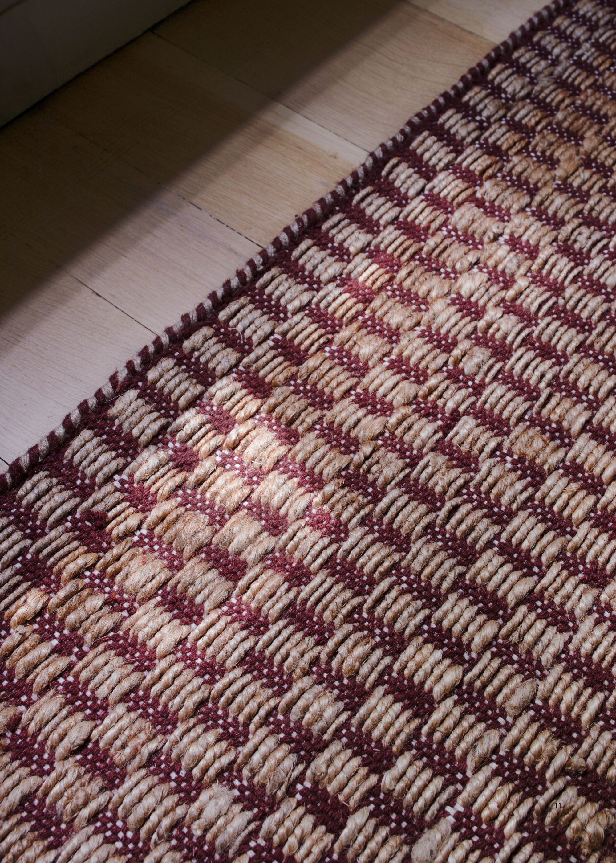 Close-up image of a red and natural jute rug.