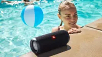 The JBL Flip 5 playing music by the pool