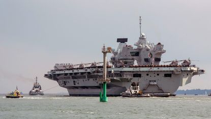 HMS Queen Elizabeth departs Portsmouth Harbour towards the open sea