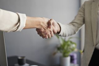 Transmit Security channel hire story illustrated by an image of two businesswomen shaking hands