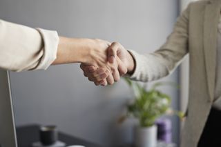 Two businesswomen shaking hands