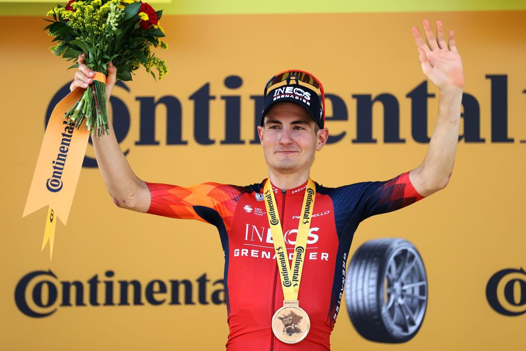 Carlos Rodriguez (INEOS Grenadiers) celebrates on the podium as stage 14 winner