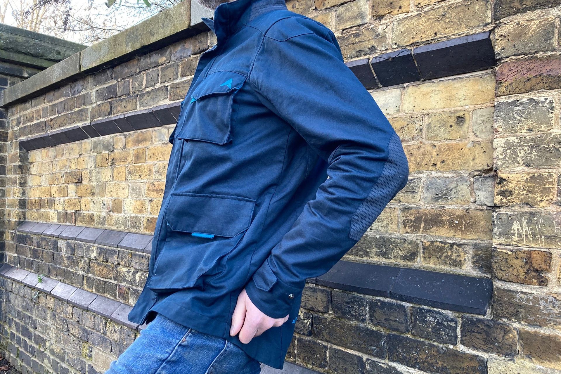 Side view of a rider wearing the Altura Grid Field Jacket
