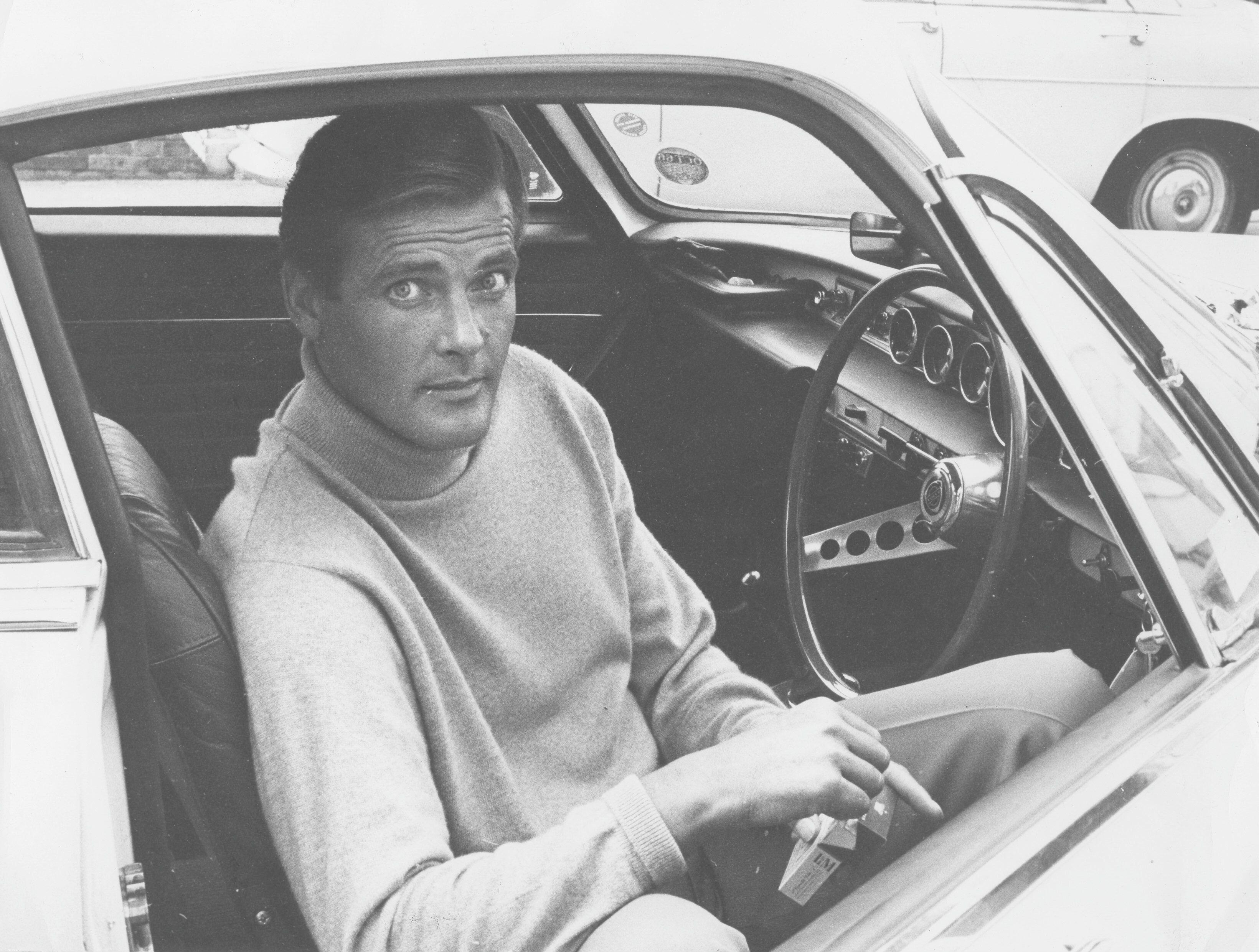 Roger Moore in a Volvo P1800. He is looking very handsome