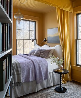 Yellow bedroom, yellow curtain, bookshelf, black framed windows