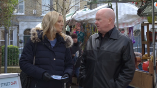 Kathy Beale and Phil Mitchell talk in the Square.