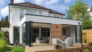 Designing a single storey extension: house extension with cladding and bi fold doors lleading onto outdoor decking image by William Goddard