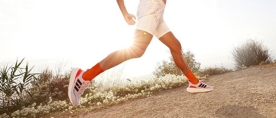 a photo of a woman running in the Adidas Ultraboost Light 