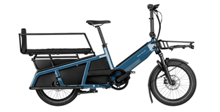 A photo of a blue cargo e-bike taken from the drivetrain side.