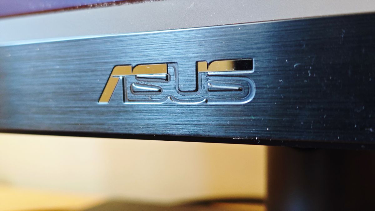 A black ASUS ProArt OLED PA32DC monitor sitting on a desk
