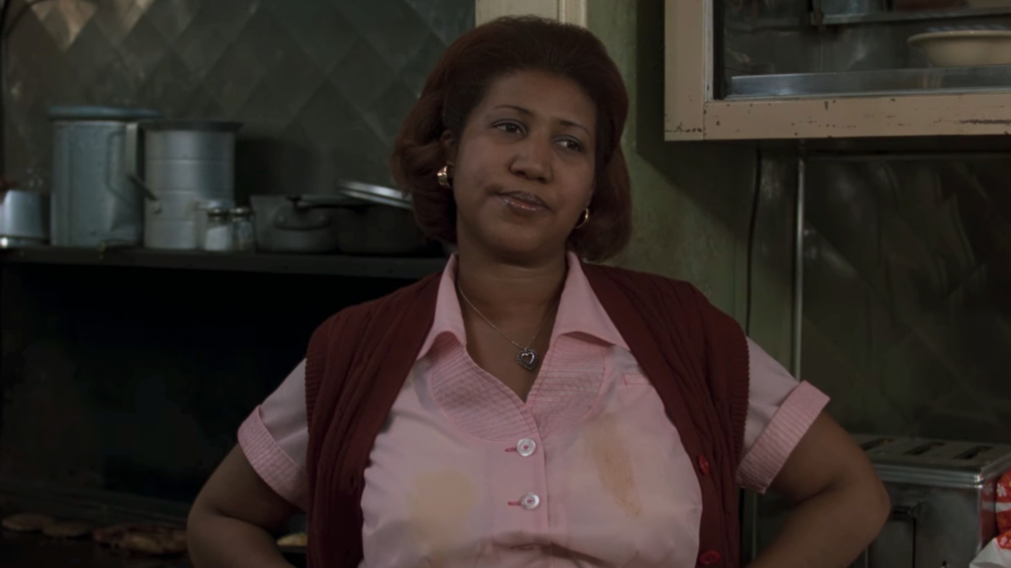Aretha Franklin wearing a waitress outfit, looking very disappointed in The Blues Brothers
