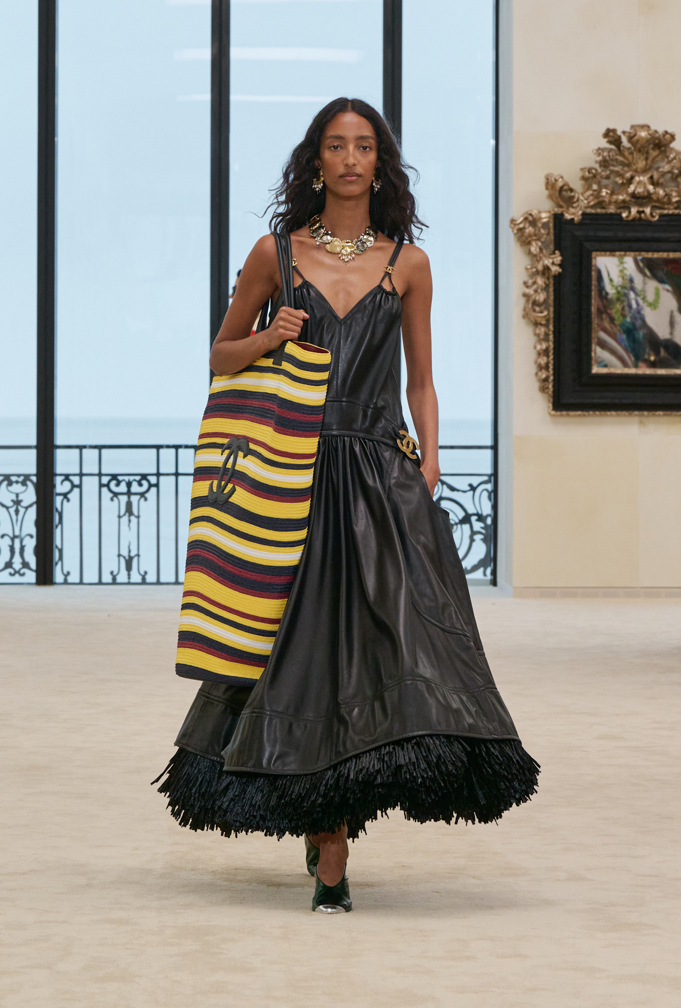 A model wore an oversized Chanel beach bag on the Cruise 2027 runway