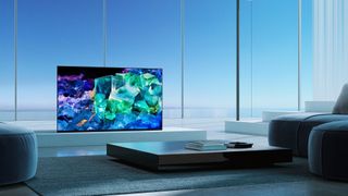 Sony A95K QD-OLED television in brightly lit modern room.