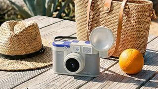 Chuzhao M3 Gray on wooden bench next to hat, orange and canvas bag on a sunny day