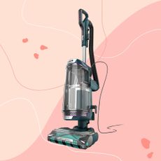 Shark PowerDetect Powered Lift-Away Upright Pet Vacuum Cleaner AZ3900UKT on a pink background