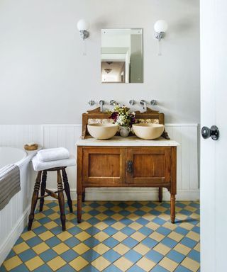 bathroom with colourful floor tiles and wooden table