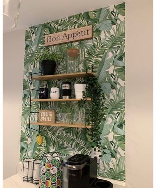 A DIY coffee bar with palm print peel-and-stick wallpaper, Macy's shelf and dangling faux plant from Ikea