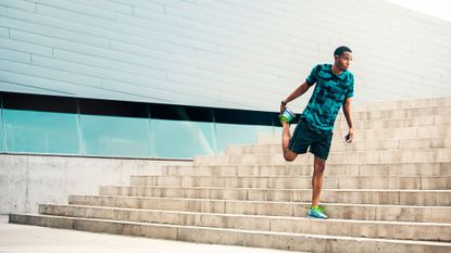 Man stretching his hip flexors before going running