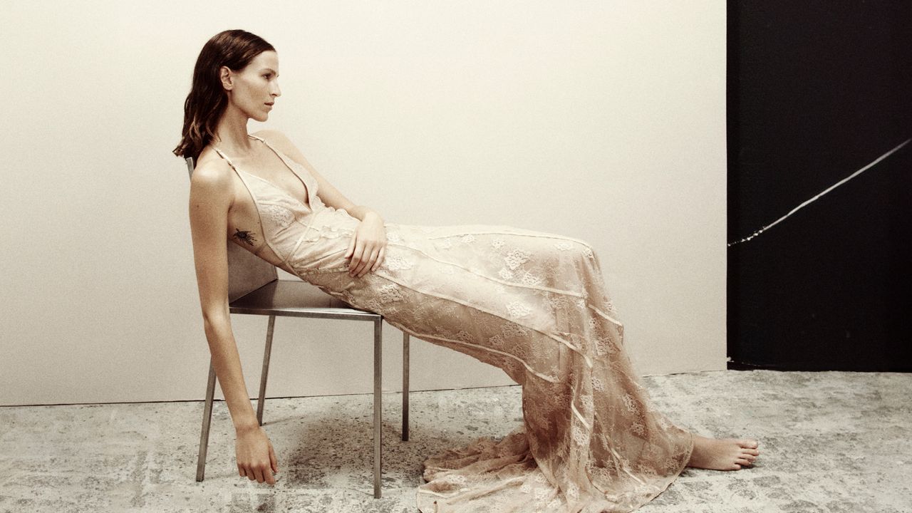 Woman in a tan gown from H&amp;M Studio Holiday Collection 2023