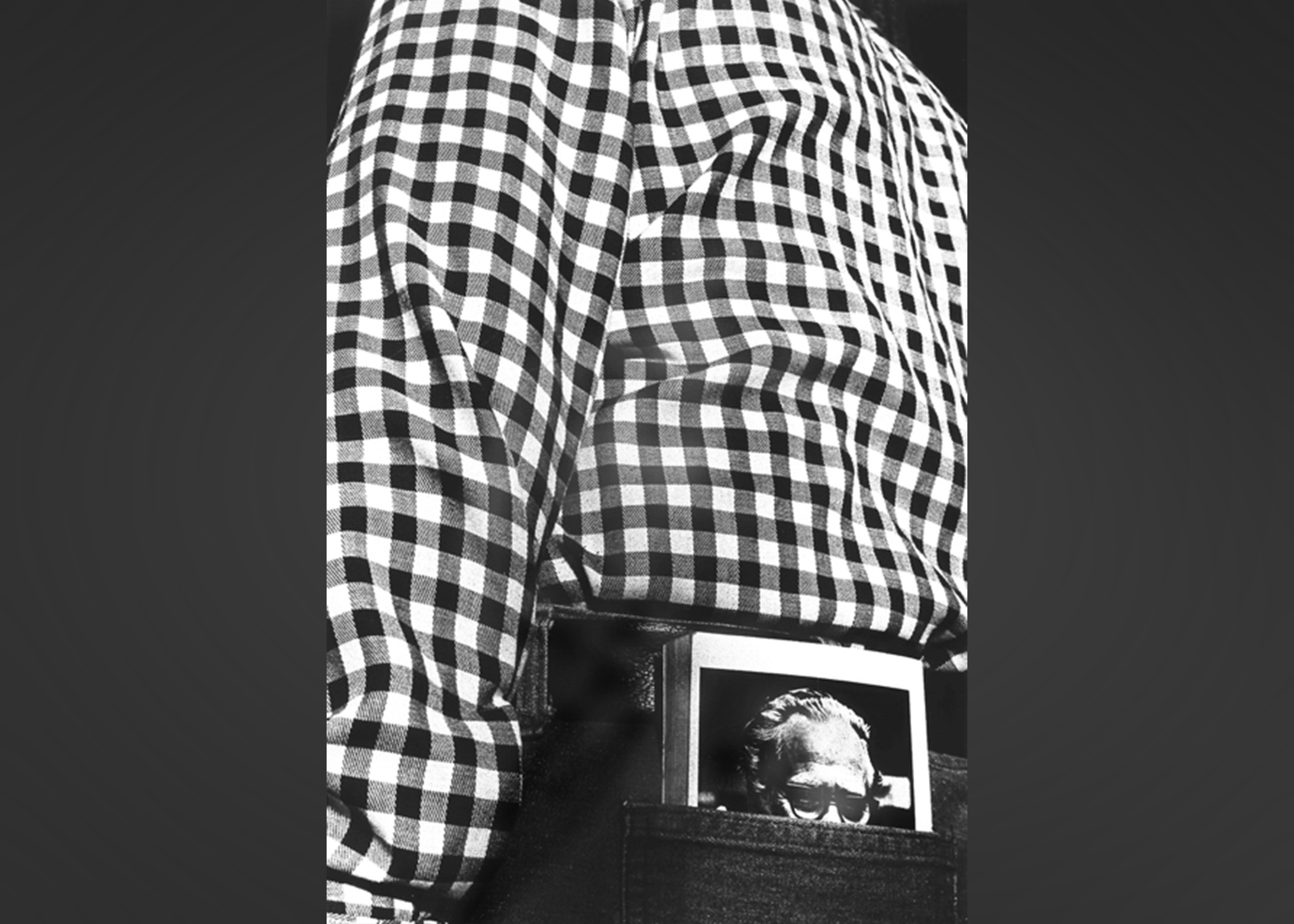 Book sticking out of trousers back pocket.
