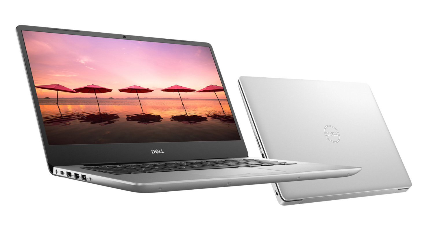 Two Dell Inspiron 14 5000 laptops, one with the screen open showing a photo of the beach, the other one is closed