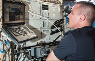 Chris Cassidy studies the Surface Telerobotics Workbench on the International Space Station to remotely operate the K10 rover on Earth at NASA's Ames Research Center in Moffett Field, Calif., in June 2013.