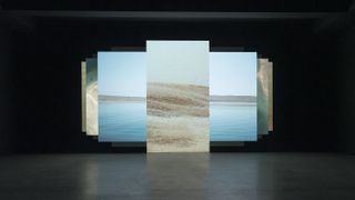 artwork on screens with images of sand and sea at 34th São Paulo bienal