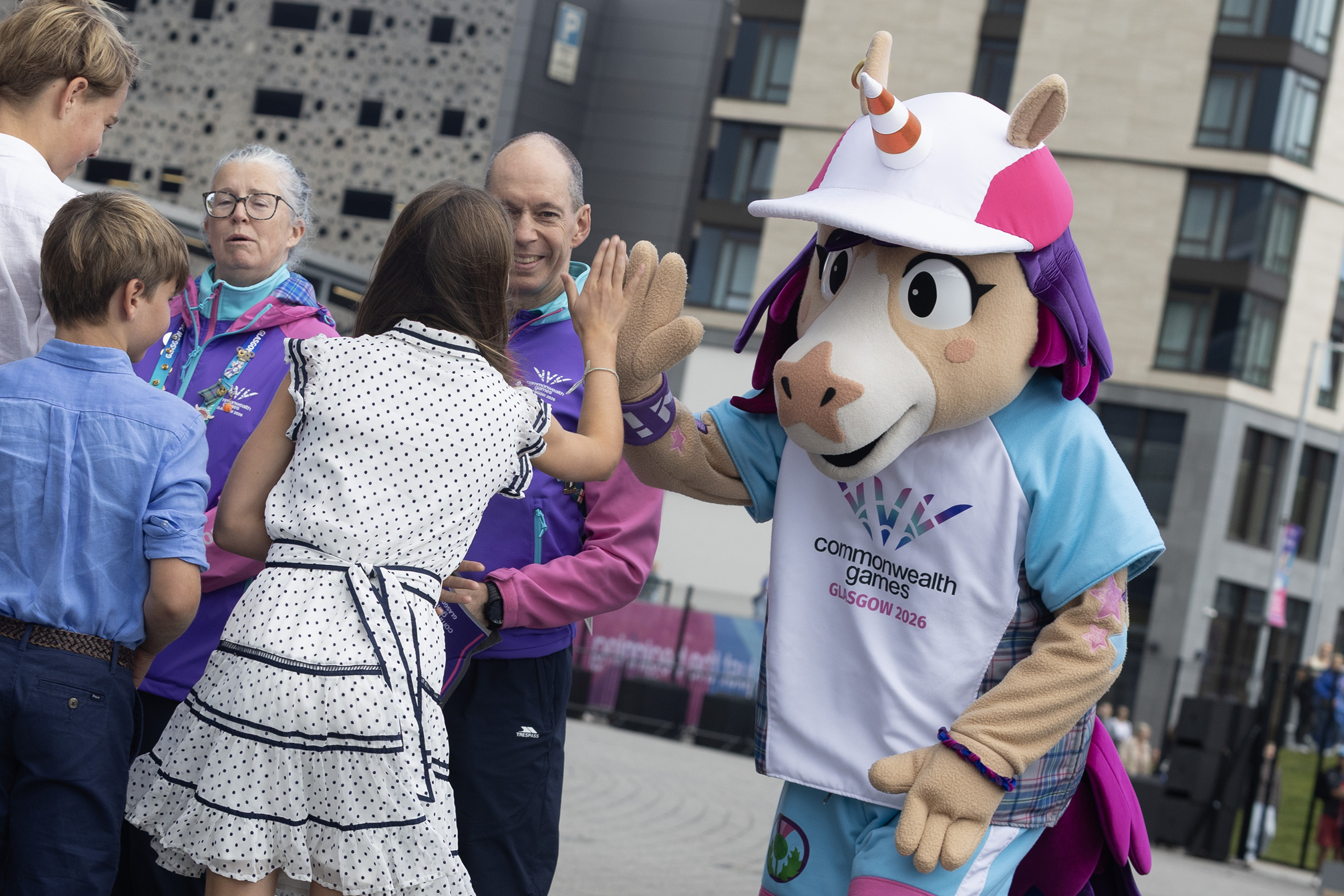Princess Charlotte high fiving a unicorn mascot