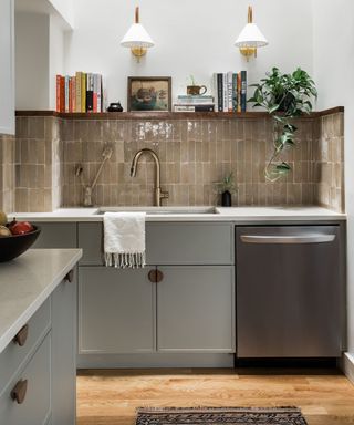 Mid gray kitchen with wood floor and brown tiled backsplash