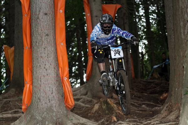A racer speeds along on the downhill track