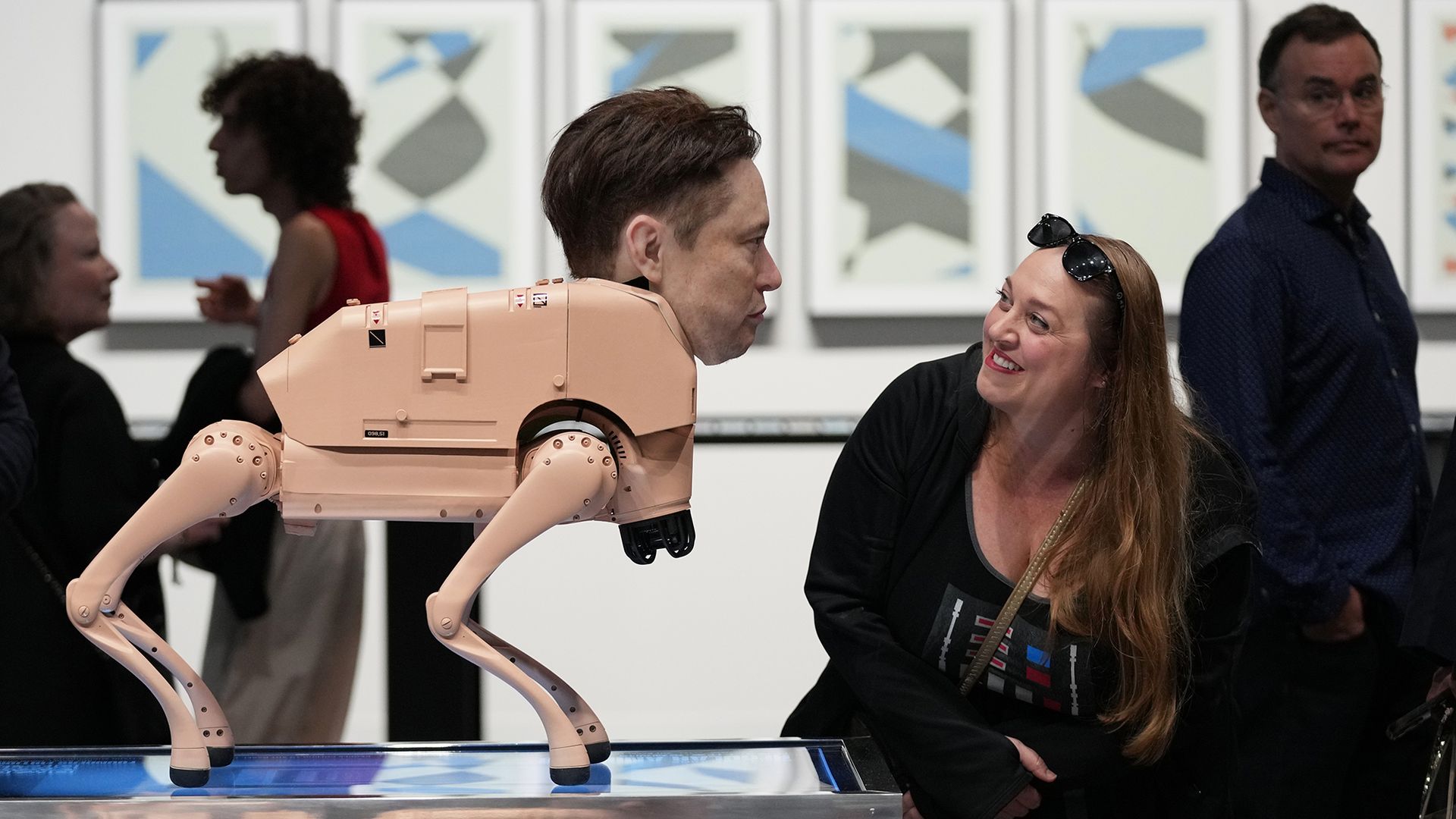 
                                A visitor looks at a robot in the likeness of Elon Musk in artist Michael Winkelmann&#039;s installation at Art Basel in Miami Beach, Florida
                            