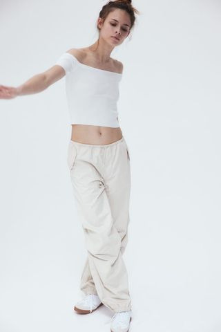 model parachute pants and white top 