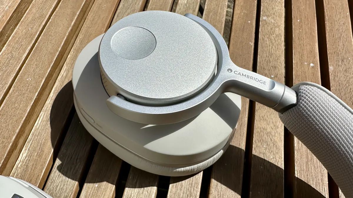 Cambridge Audio Melomania P100 headphones on a wooden surface