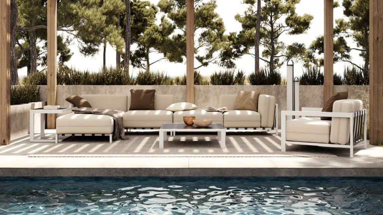 An outdoor furniture set in a backyard with pool and pergola