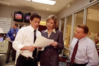 rob lowe and allison janney look over papers in an office on the west wing