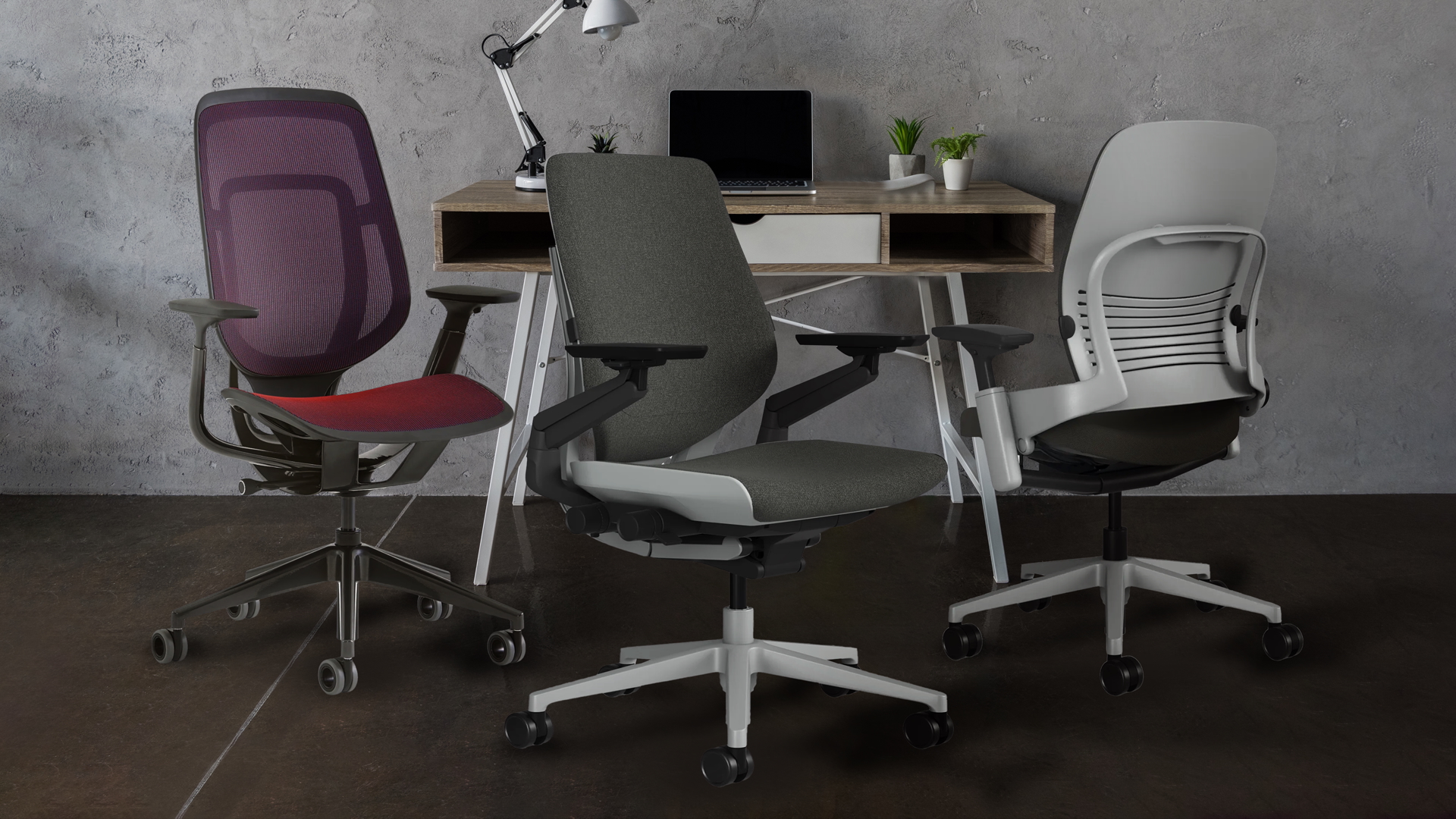 Three Steelcase chairs arranged in front of a desk