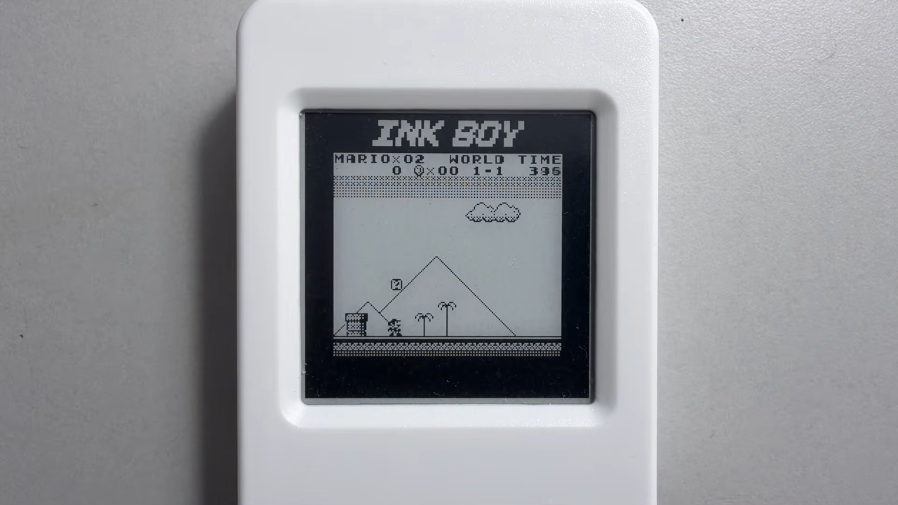 Ink Boy E-Ink Game Boy handheld unit sitting on grey surface.
