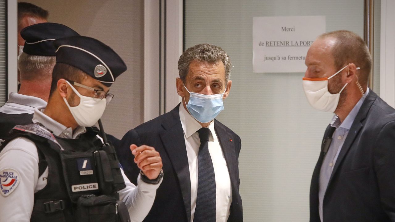 Former French President Nicolas Sarkozy leaves court after the opening of his trial for corruption and influence pedalling.