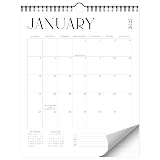 A white wall calendar with black text and ring-binding, with the first page turning in the bottom right-hand corner