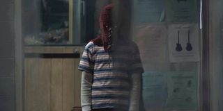 Brandon Breyer in his mask in a diner in Brightburn