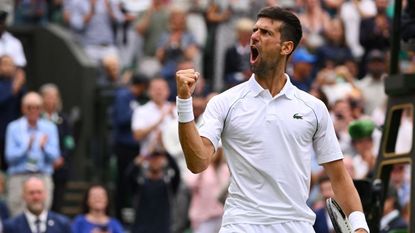 Serbia's Novak Djokovic celebrates winning against Italy's Jannik Sinner during their men's singles quarter final tennis match on the ninth day of the 2022 Wimbledon Championships 