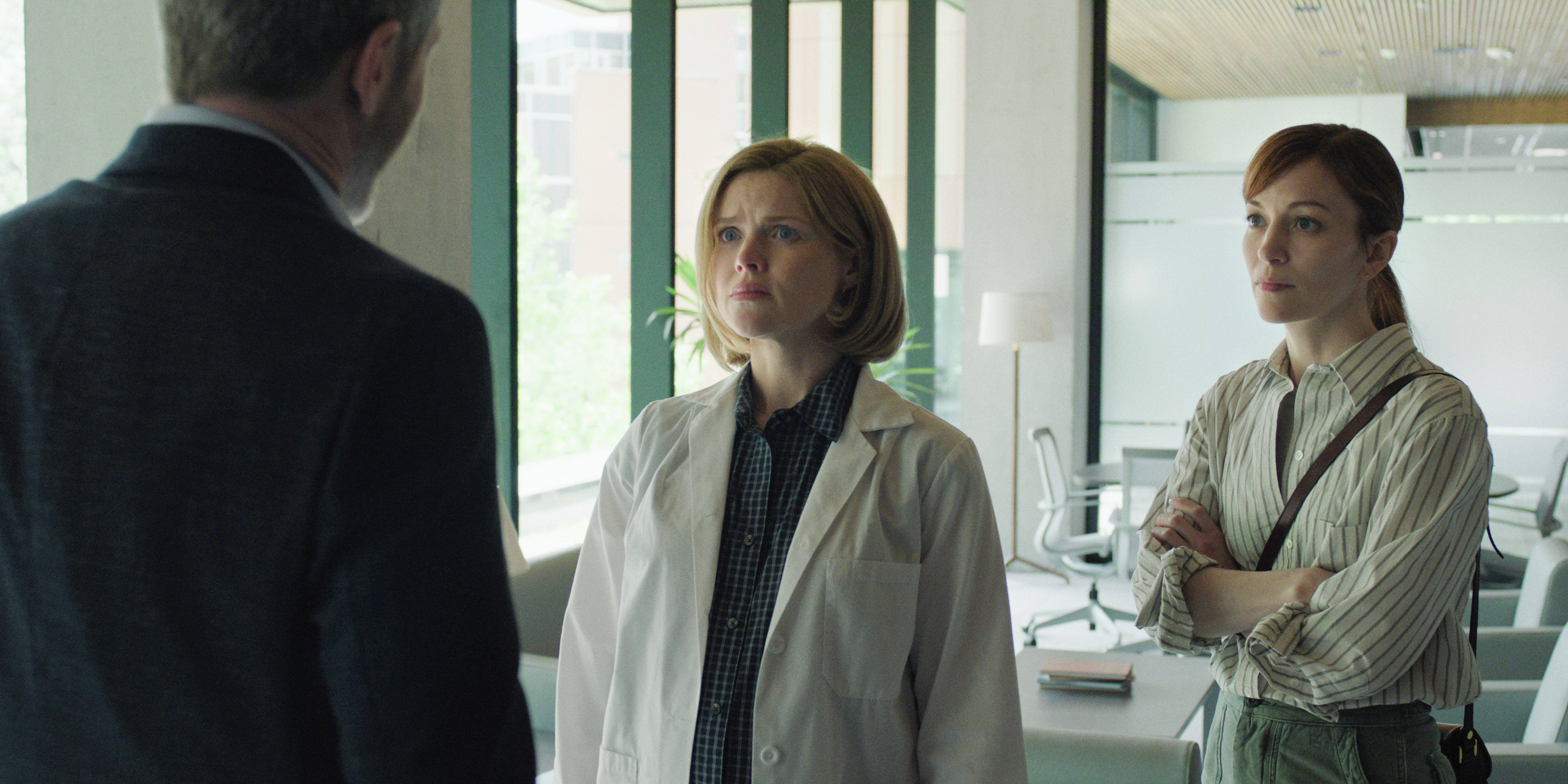 Erin Richards as cheryl and Britt Lower as rachel investigating and having a conversation with a man in I Will Find You