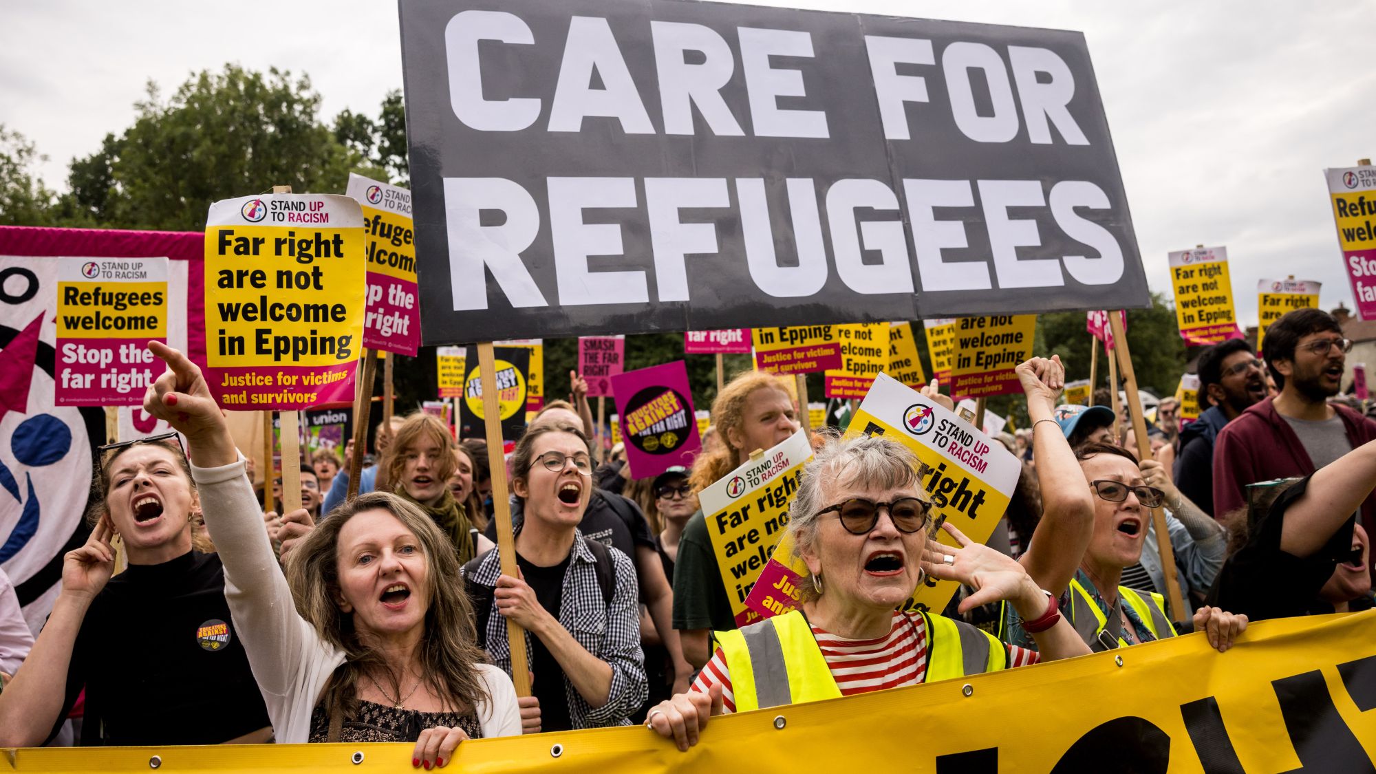 Counter-protesters from Stand Up To Racism march towards the Bell Hotel where a protest is taking place against the use of the hotel as migrant accommodation on July 27, 2025 in Epping, England.
