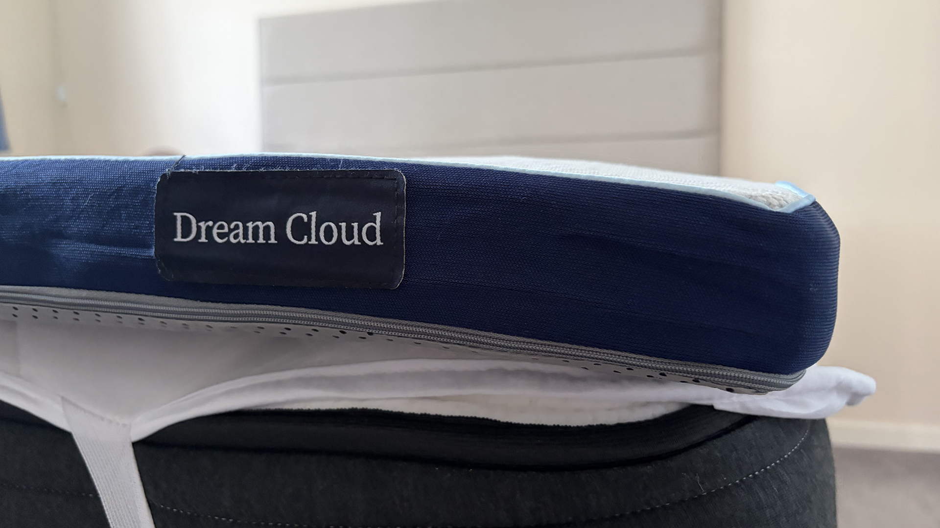 A close up of the DreamCloud Softer Mattress Topper on a mattress in our reviewer's bedroom