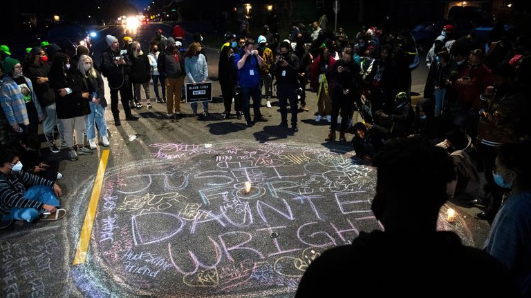 Night time protest for justice for Daunte Wright, chalk writing in the street
